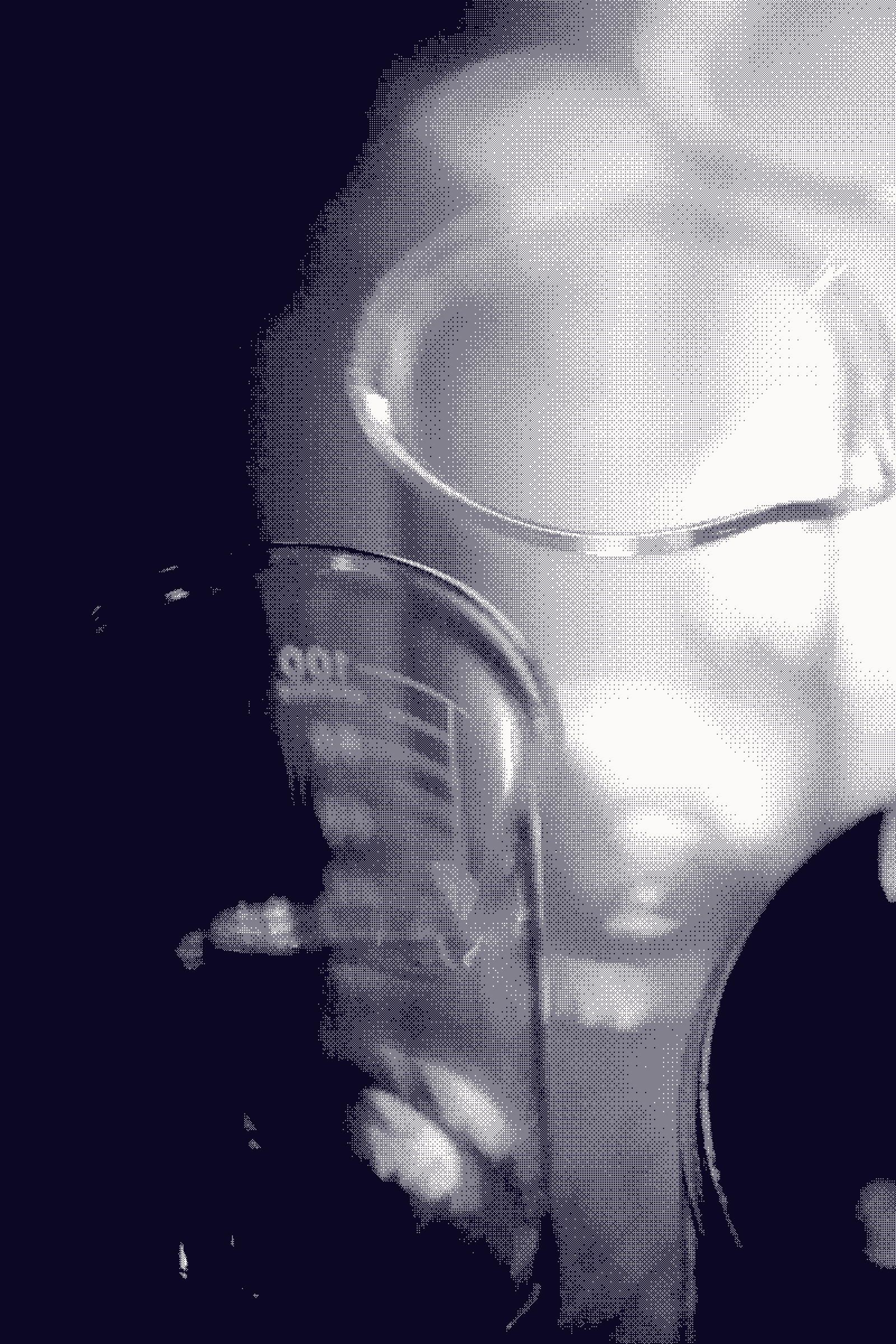 Empty laboratory beakers on a dark bench, their rims catching a single warm light