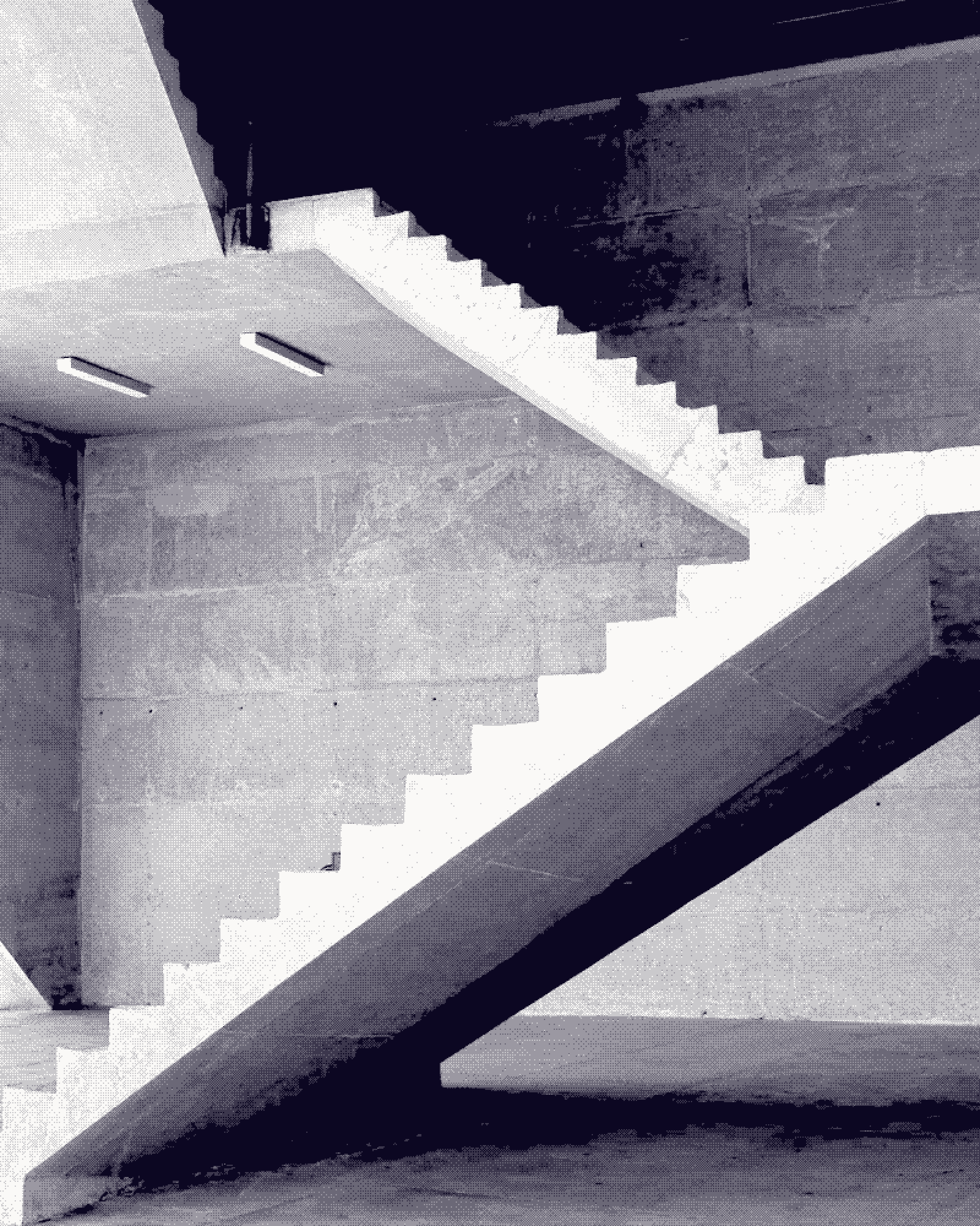Cast concrete stair flights crossing a bare wall in hard diagonal light, black and white